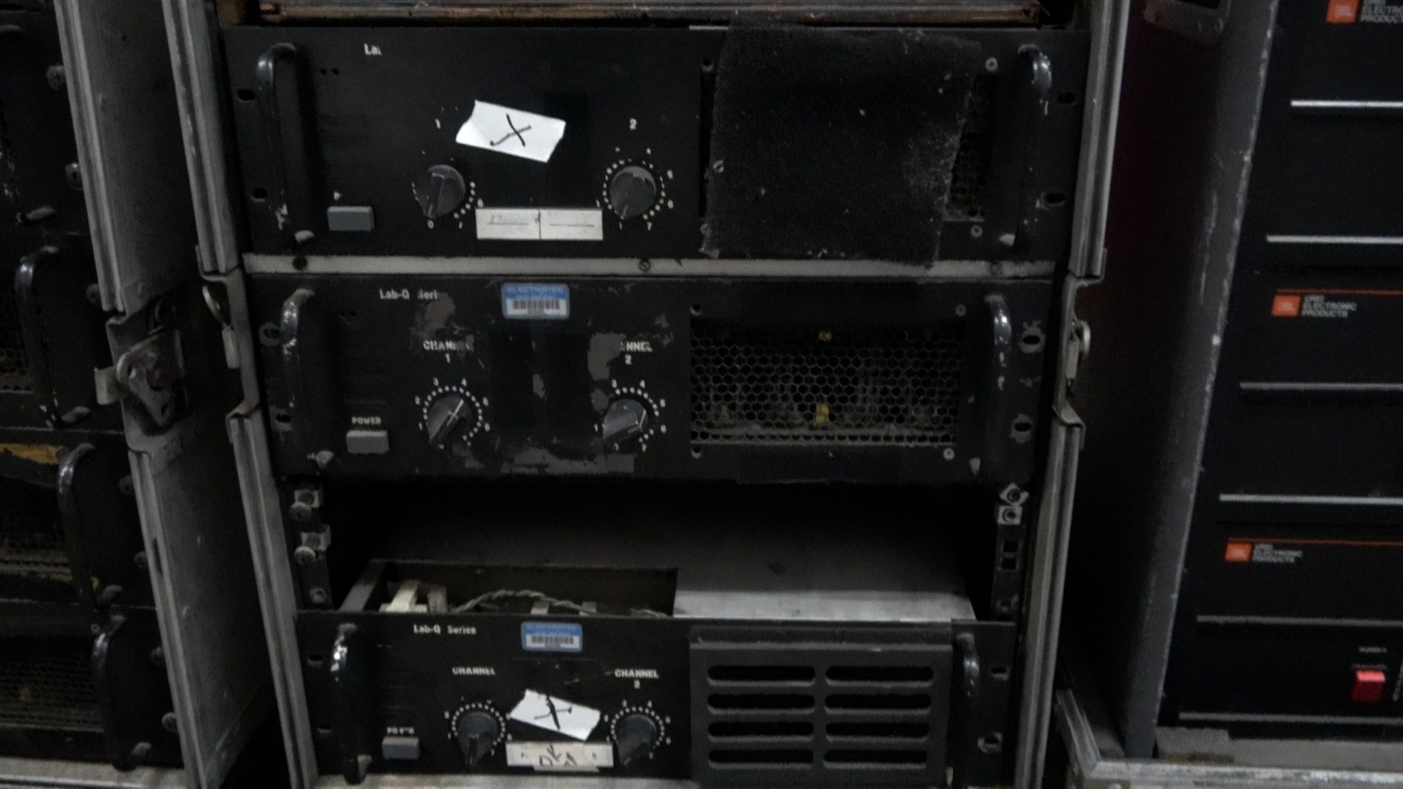 Rack with two nonworking JBL 6233 amplifiers marked X